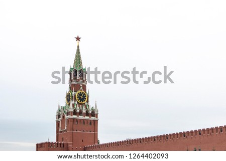 Clock tower building peak in Kremlin, Moscow isolated on a white cloudy background
