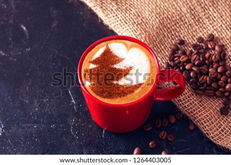 cup of cappuccino coffee with Christmas tree symbol pattern on milk froth
