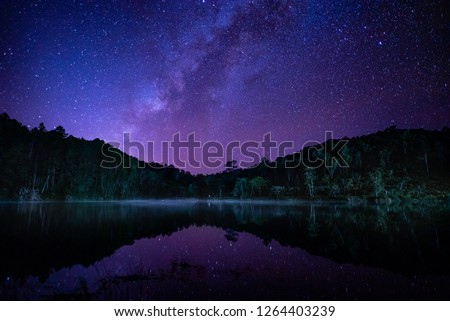 Night landscape with colorful Milky way and purple light between the mountain.Starry sky, Winter,Beautiful background.