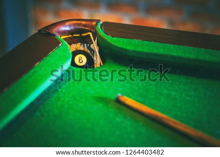Vintage Photography style of number eight ball in the pocket of snooker table, selected focus.