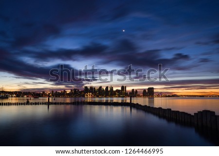 Moon light dawn over San Diego skyline with pier in foreground. More similar shots in portfolio.