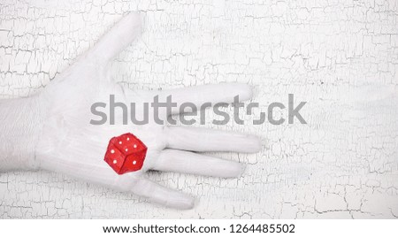 the hand drawing the cube for games and fortune-telling