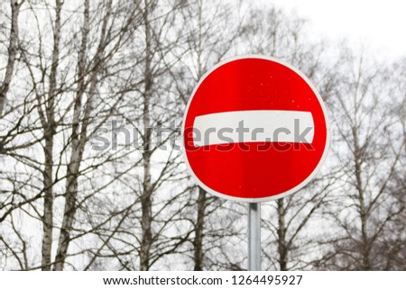 Red, round stop sign near road.