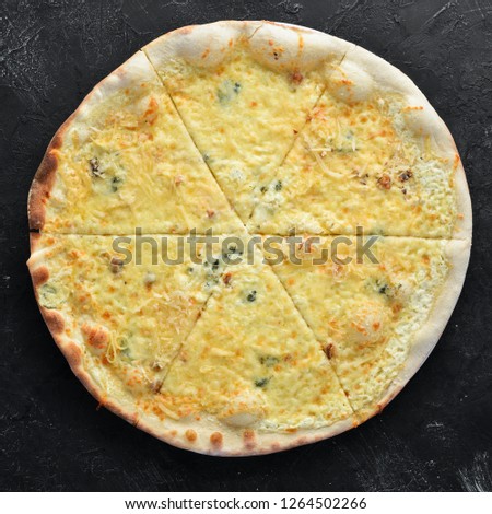 Pizza with cheese and vegetables. Italian traditional dish. Top view. Free copy space. On a black background.