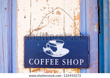 Coffee shop sign hanging on the door