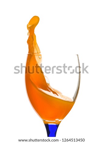 Beautiful and diverse subject. Beautiful and stylish glass and glass with orange juice poured and splashed on a white insulating background.