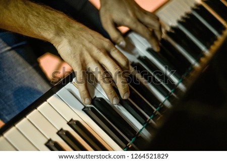 Beautiful and diverse subject. Piano keys with pianist hands at close range.