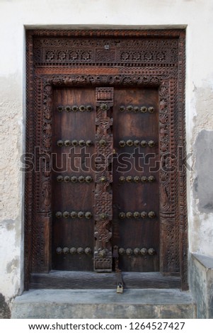perfect up-right picture of historic typical wooden door in Stone town zanzibar - Tanzania