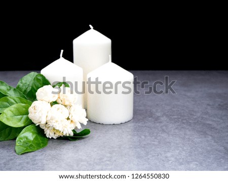 Jasmine flowers and candles on a black background, Copy space for text