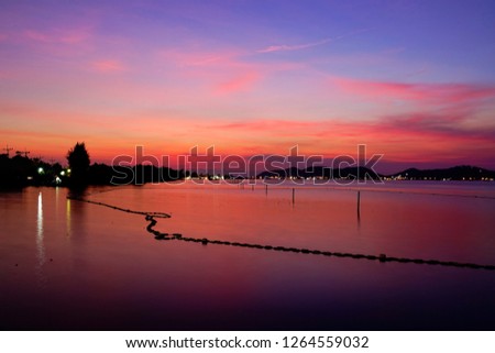 Long exposure shot of Lake view at Southern Thailand on sunset time background,Long exposure shot lake view with colored sky over lake on sunset time background.                        
