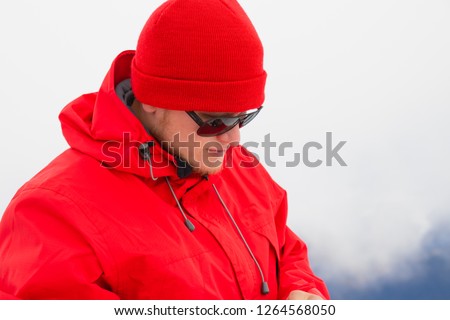 A man in red sportswear in the mountains. Sports in the mountains.