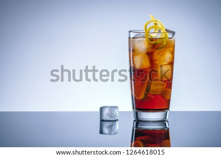 Coke cocktail with ice and lemon, alcohol bar