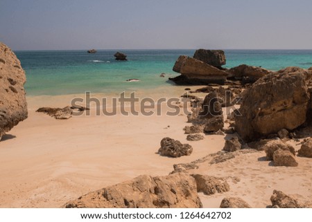 A beach with large boulders by the Arabian Sea. Oman