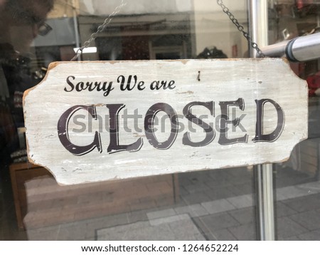 shop sign saying sorry we are closed