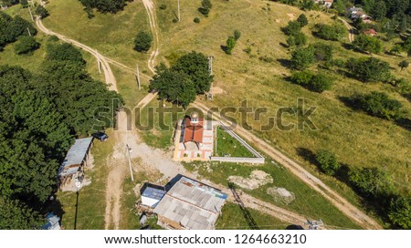 aerial view of a orthodox chapel in the middle of the forest in a small village in Bulgaria drone picture