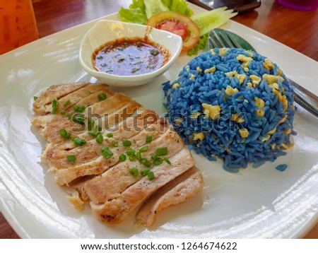 Fried rice with pea flowers served with pork steak