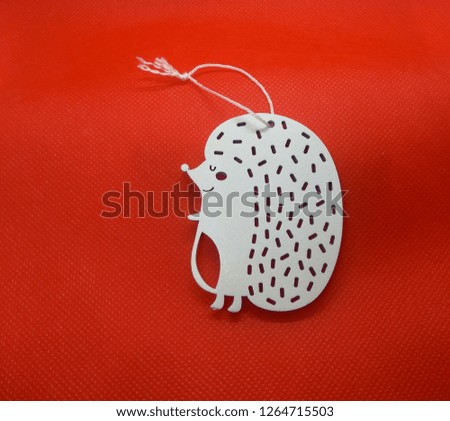 Christmas tree decorations: wooden crafts white new year decorations, animals on red background. 