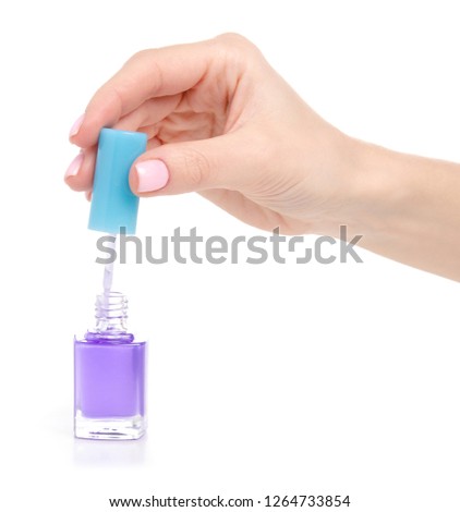 Nail polish blue colorless sparkles in hand on white background isolation