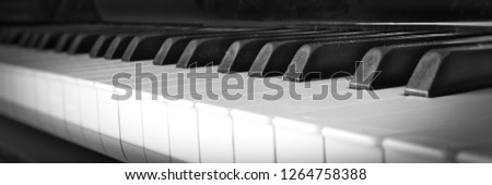 Piano keys close up with black and white keyboard and shallow depth of field.