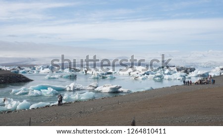The beautiful cold winter landscape of the Jokulsarlon glacier lagoon, Iceland, in the winter with snow-capped mountain as a background. 