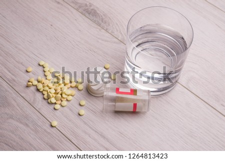 Tablets and a glass of water on the table