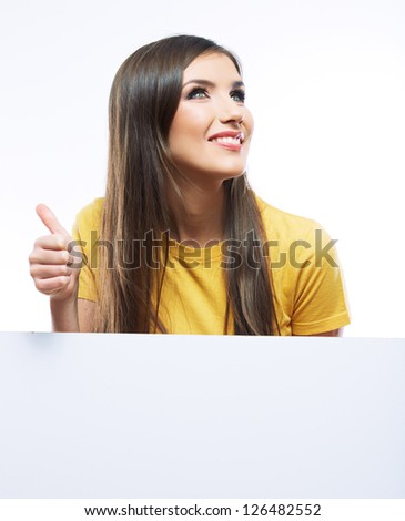 Teenager girl hold white blank paper. Young smiling woman show blank card. Girl portrait isolated on white background. Thumb up.