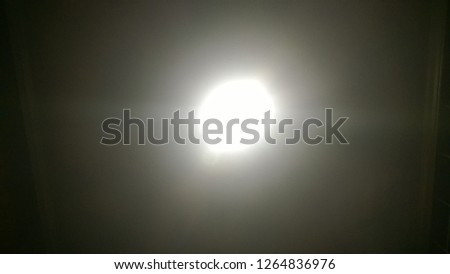 The texture and background, wallpaper of the glare of a lamp in a public or living room, resembling a full moon.