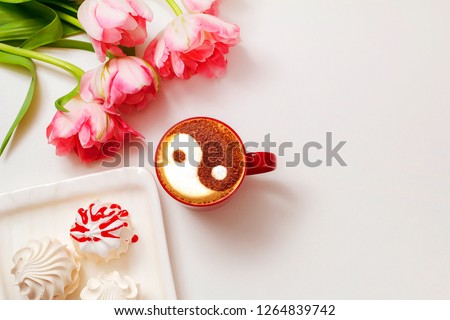 symbol of dao balance and harmony of life yin and yang drawn on milk foam cappuccino cinnamon