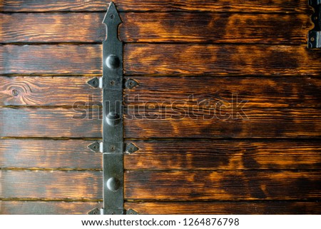 The texture of the tree with elements of forged metal. Wood texture. Brown board background, Natural background of brown boards wide and narrow