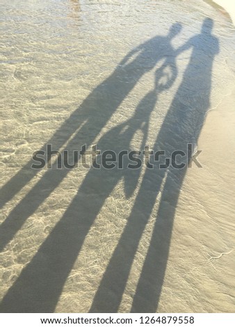 Family silhouettes on a sand