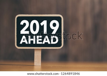 Year 2019 Ahead Concept Sign with wooden background.