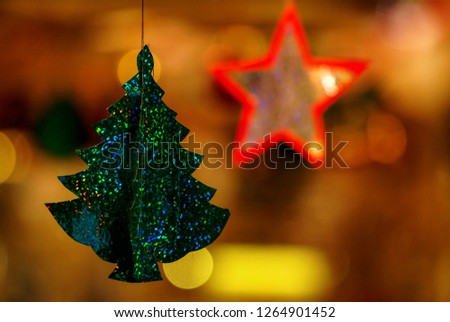 Fluffy branches of Christmas tree decorated with elegant and stylish glass balls in golden tones and garlands