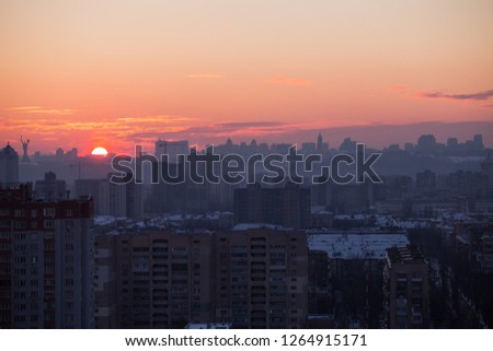 Sunset in Kiev, evening view of the panorama of the city, the church and the statue of the Motherland.  Evening color urban landscape.