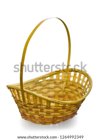 Beautiful and diverse subject. Beautiful and stylish antique basket woven of wicker and wood with a handle on a white insulating background.