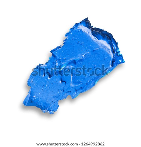 spots of blue oil paint on a white palette