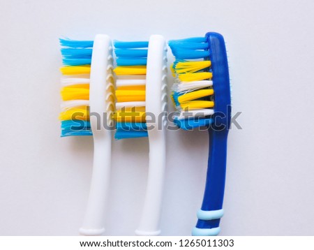 Flat lay composition with manual toothbrushes on white background.Toothbrush and toothpaste.op view, flat lay. Minimal concept, space for text.set of multicolored toothbrushes on white.