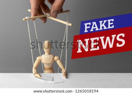 Fake News. The correspondent as the doll controls the puppeteer. False information to deceive people Royalty-Free Stock Photo #1265018194
