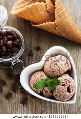 Coffee ice cream and coffee beans on a old wooden table