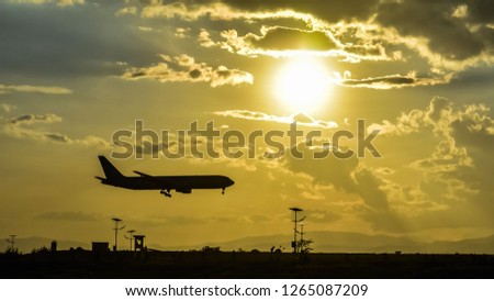 takeoff of the plane on the airfield against the background of the bright sun and beautiful cloudy sky