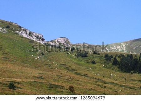 fantastic mountain cliff with light blue sky, natural landscape photo
