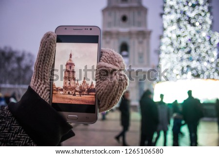A girl takes pictures on the phone the Church Kiev Sofievskiy Sobor