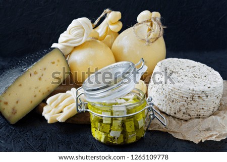 Different types of cheese on a black background. Cheese platter.