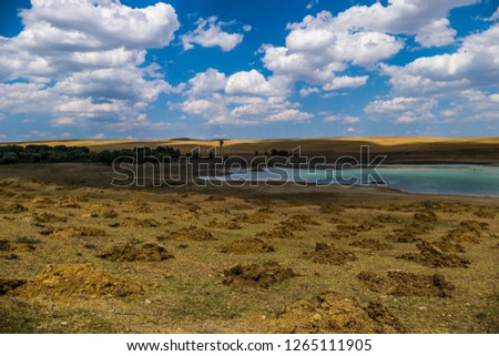 tiny dam landscape pictures, white clouds in the blue sky,