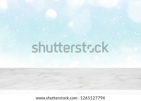 Wood table top on winter snow and white bokeh abstract background and used for montage or display products.