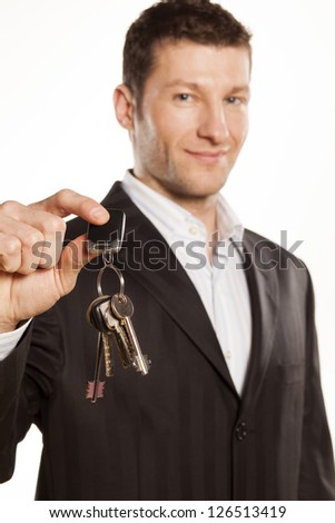 handsome businessman gives a bunch of keys