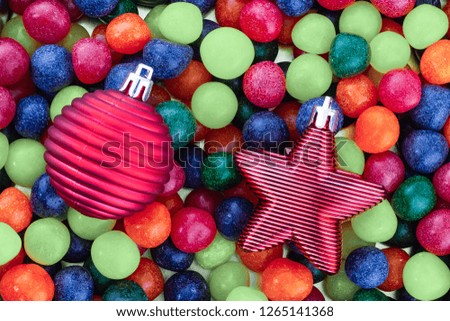 red frosted star ball christmas decoration toy christmas tree closeup green navy blue candy round