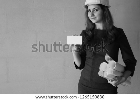 woman with a blank sheet of paper in his hand on a construction site