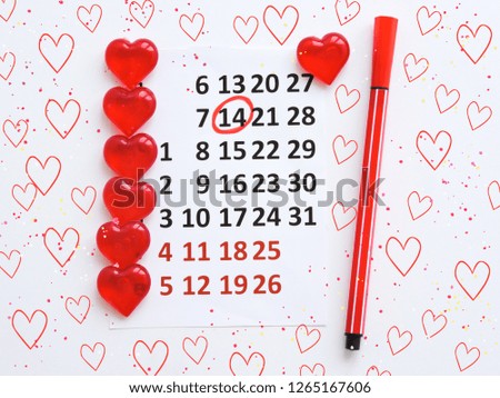 Calendar page with the red hearts on February 14 of Saint Valentines day. Romantic, Valentine's Day concept.Valentine's day concept with heart.Top view.Calendar showing the date 14th of February.