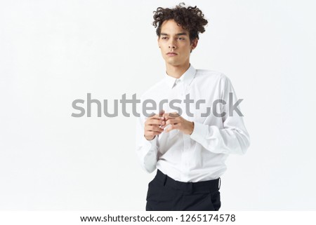 Cute curly-haired man in a white shirt earrings           