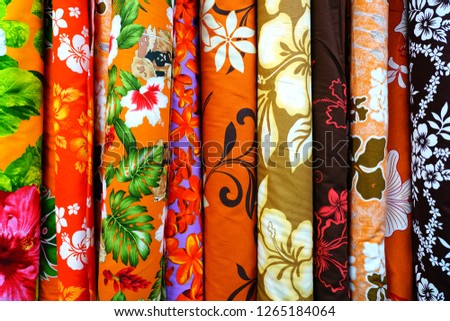 Bolts of colorful Polynesian fabrics with tropical flower motifs in Tahiti